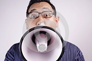 Young Man Shouting with Megaphone, Angry Expression