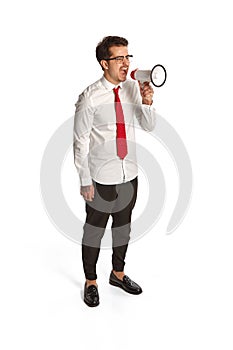 Young man shouting at megaphone isolated over white background. Concept of business, office lifestyle, success, career