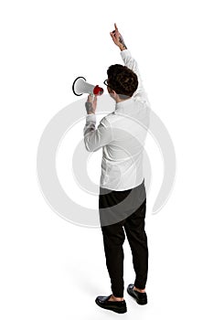 Young man shouting at megaphone isolated over white background. Concept of business, office lifestyle, success, career