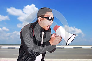 Young Man Shouting with Megaphone, Motivating Concept