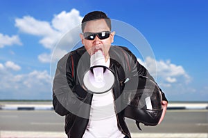 Young Man Shouting with Megaphone, Motivating Concept