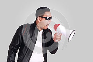 Young Man Shouting with Megaphone, Motivating Concept
