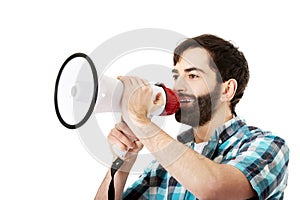 Young man shouting through megaphone.