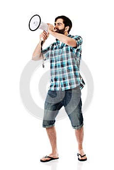 Young man shouting through megaphone.