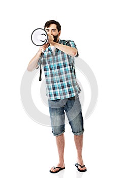 Young man shouting through megaphone.