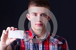 Young man showing blank business card