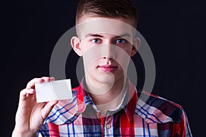 Young man showing blank business card