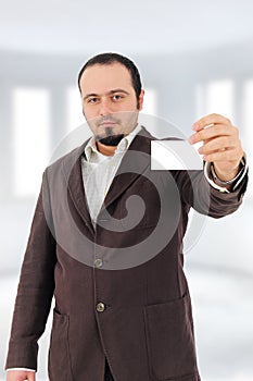 Young man showing blank card