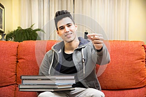 Young man showing difference between USB drive and