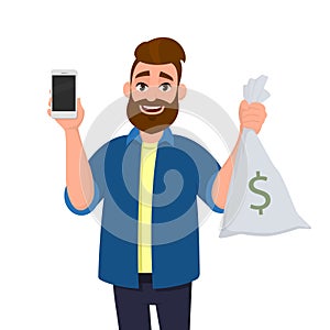 Young man is showing or holding money bag, cash bag. Man shows a blank or empty screen display of cell, mobile, smartphone in hand