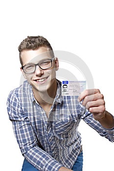 Young man showing off his driver license