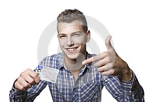 Young man showing off his driver license photo