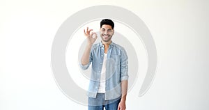 Young man showing ok gesture with hand