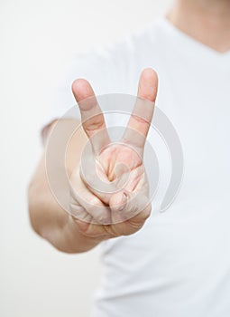 Young man showing a sign of victory