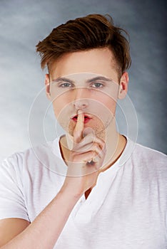 Young man showing silent gesture.