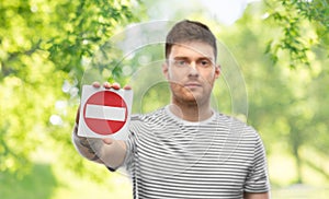 Young man showing stop sign