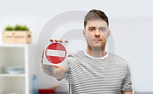 Young man showing stop sign