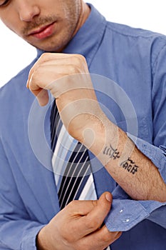 Young man showing tattoo in forearm photo