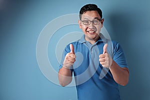 Young Man Showing Thumbs Up Gesture OK Sign