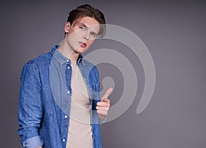 Young man showing thumps up with positive