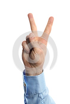 Young man showing victory gesture on white