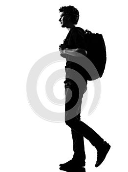 Young man silhouette backpacker walking