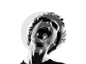 Young man silhouette screaming angry portrait photo