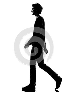 Young man silhouette smiling walking