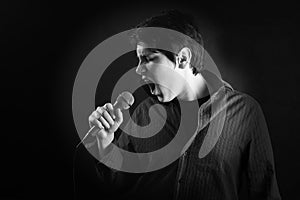 Young man singer with microphone expression