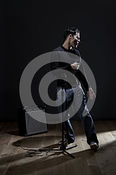 Young man singing into microphone close-up