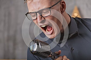 Young man singing with microphone