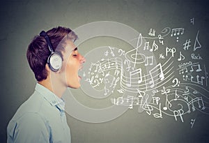 Young man singing with music notes coming out of mouth