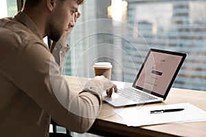 Young man sit by laptop prepare to enter personal account