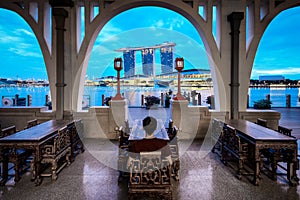 Young man sits and enjoy the view of marina bay sands, Singapore