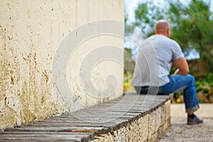 Young man sitting alone on park bench