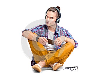 Young man sitting on the floor and enjoying music