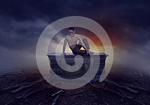 Young man sitting on a grave