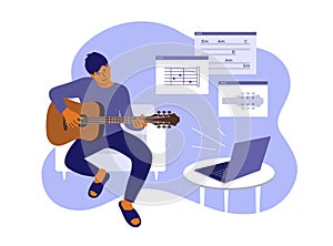 Young man sitting home watching online video course and learning playing guitar