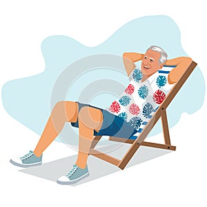 Young man sitting in lounge deck chair at the beach and relaxing