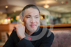 Young Man Sitting at Restaurant