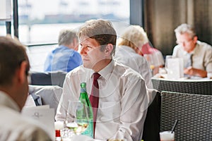Young man sitting in restaurant on event party