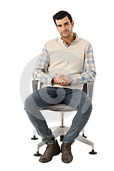 Young man sitting in swivel chair photo