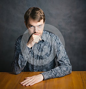 Young man sitting at a table.