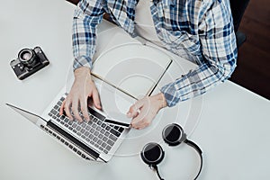 Young man sitting at the table and shopping online