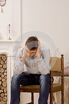 Young man sitting thinking in the living room