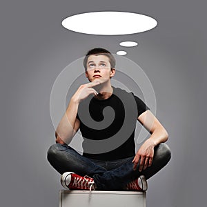 Young man sitting and thinking about something