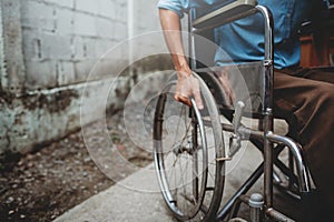 Young man sitting on wheelchair, Disabled concept outdoor.
