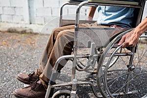 Young man sitting on wheelchair, Disabled concept outdoor.