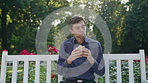 Young Man Having a Snack in the Park