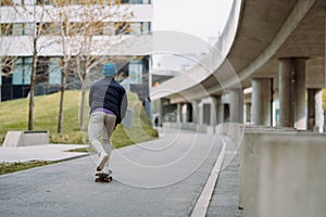 young man skater riding on skateboard. skateboarding city outdoor. Banner copy space